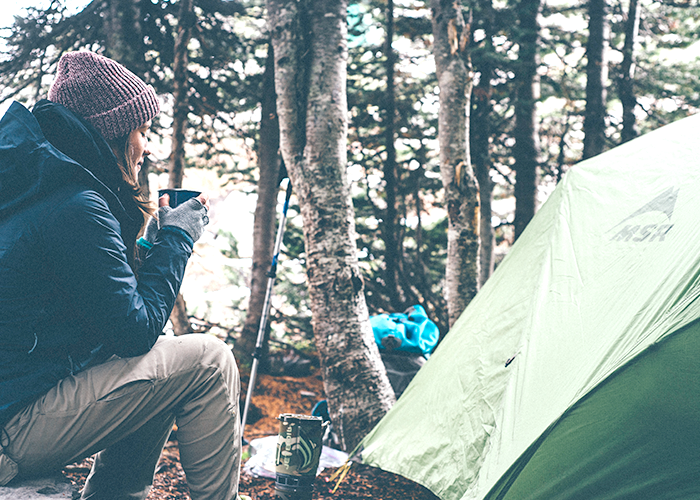 woman-sitting-with-tent