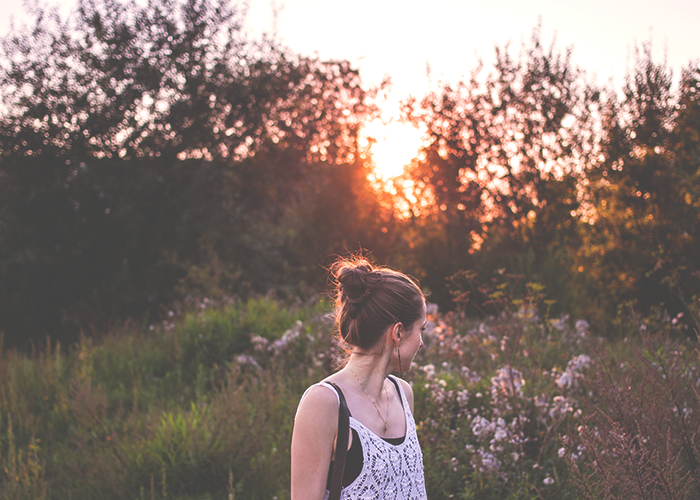 tfd_woman-standing-in-field-with-flowers