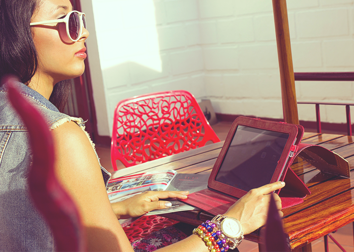 tfd_woman-sitting-on-red-table-with-ipad-working