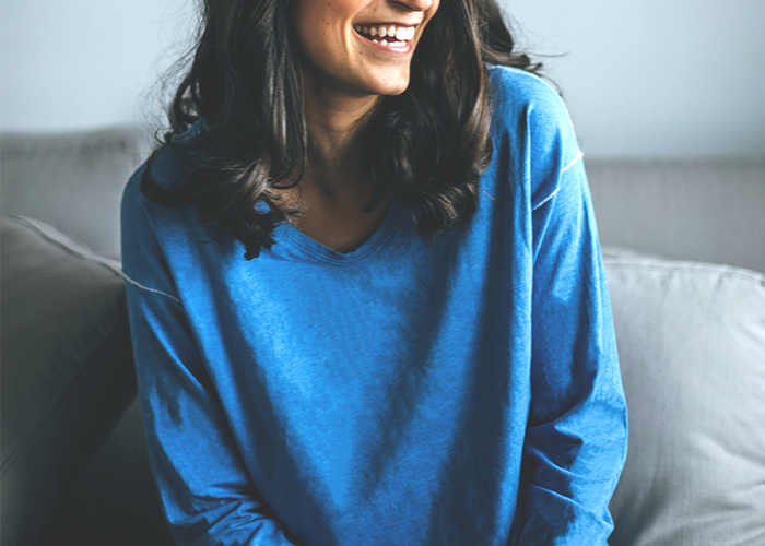 tfd_young-woman-blue-sweater-laughing