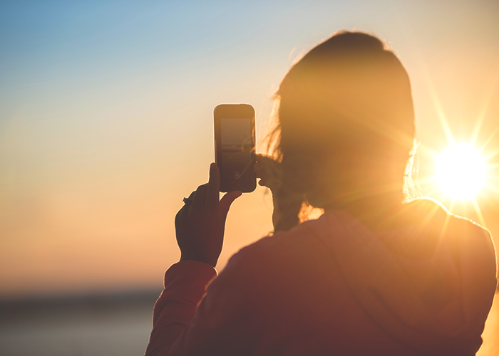 woman-on-phone-in-sunlight