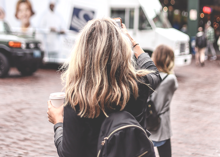 tfd_girl-standing-near-public-market-seattle-sign