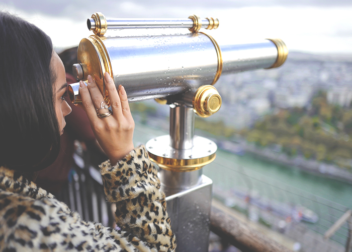 woman-in-leopard-coat-looking-out-on-city