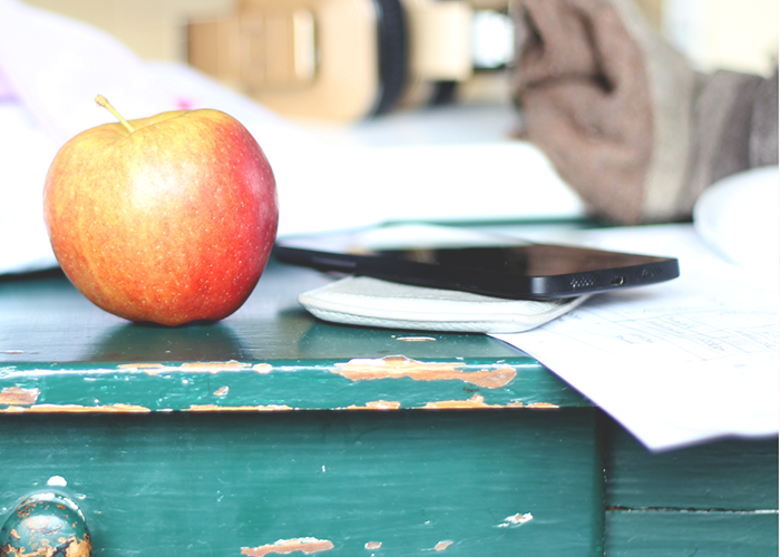 teachers-desk-with-apple-and-phone
