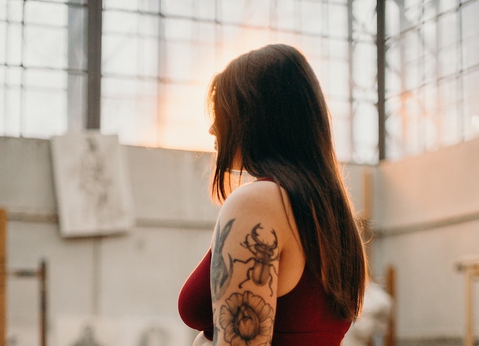 Woman in Black Underwear With Black Floral Tattoo on Her Arm